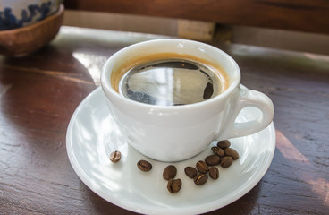 Black coffee on a wooden table in a coffee shop