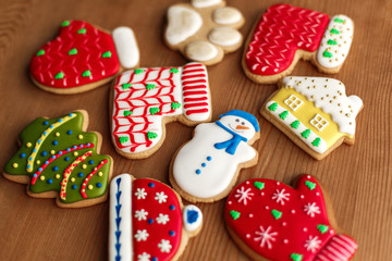 Fototapeta na wymiar Colorful christmas cookies set lay on wooden table. Holidays food and decoration concept.