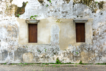Old brick wall texture with wooden window Traditional Chinese architecture , Shabby building facade with damaged concrete. Copy space