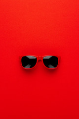 studio shot of red sunglasses. summer is coming concept. vertical orientation
