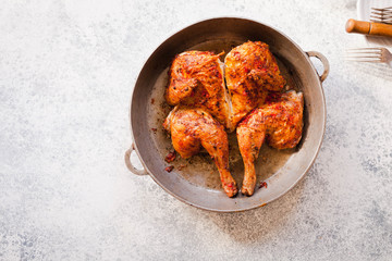 Grilled fried roast Chicken Tabaka in frying pan 