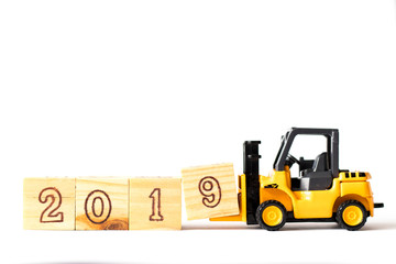 Toy forklift hold letter wood block 9 to complete word 2019 on white background (Concept for happy new year 2019)