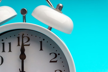 Clock on blue background with selective focus and crop fragment. Copy space concept