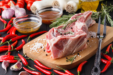 raw meat assortment - beef, lamb, chicken on a wooden board