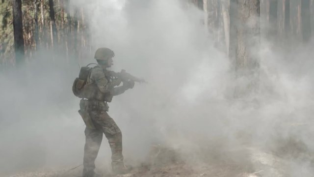 US Army Soldiers Patrol In A Smoky Forest