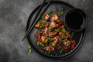 sweet sticky pork served with chives and  sesame seeds