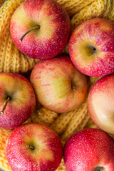 red apples autumn leaves on wooden background