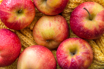 red apples autumn leaves on wooden background