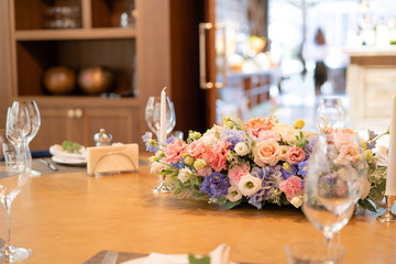 beautiful flower arrangement. Wedding Banquet or gala dinner. The chairs and table for guests, served with cutlery and crockery.