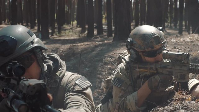 Soldiers are fighting in a trench in a smoky forest