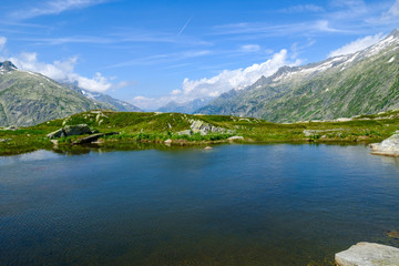 Naklejka na ściany i meble Lake in Switzerland mountains, near Grimsel pass