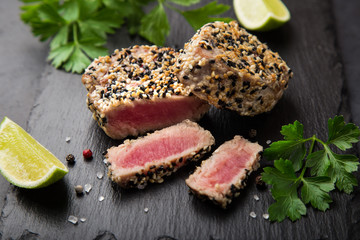 grilled sesame tuna steak on black background