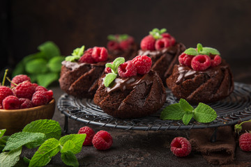 delicious chocolate muffins with chocolate topping and fresh raspberry