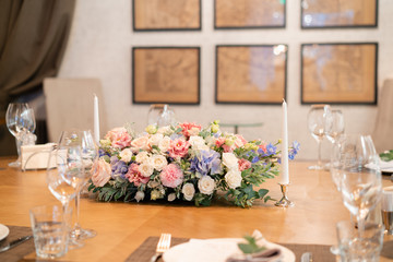 beautiful flower arrangement. Wedding Banquet or gala dinner. The chairs and table for guests, served with cutlery and crockery.