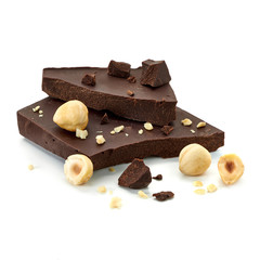 Hazelnuts / filberts with broken chocolate blocks isolated on white background