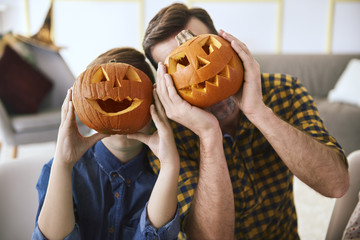 Father and boy with scary Halloween pumpkin - obrazy, fototapety, plakaty