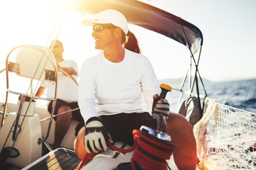 Fototapeta premium Attractive strong woman sailing with her boat