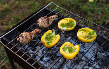 Eggs in bolgarian pepper with toast and chicken grilled on coals in the grill