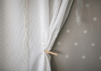 White curtain on grey wall 