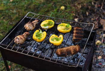 Eggs in bolgarian pepper with toast and chicken grilled on coals in the grill