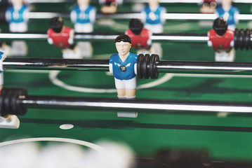 Fototapeta premium Table football in the entertainment center. Close-up image of plastic players in a football game