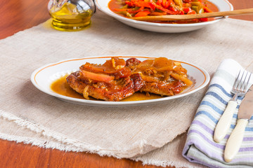 American food - pork chops in apple sauce with honey on a plate
