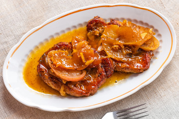 American food - pork chops in apple sauce with honey on a plate