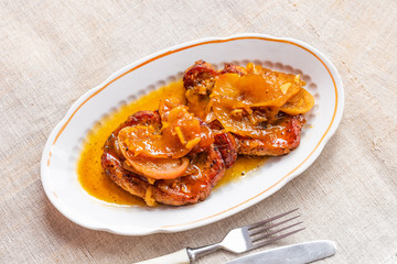 American food - pork chops in apple sauce with honey on a plate