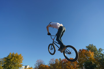 Fototapeta na wymiar Image of the biker doing stunt in the blue sky