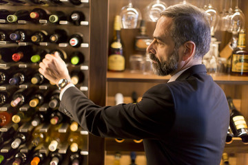 Man chooses a bottle of wine