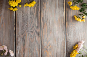 Autumn background. Flowers on a brown wood background. Place for inscription. Background for autumn holidays and thanksgiving day.