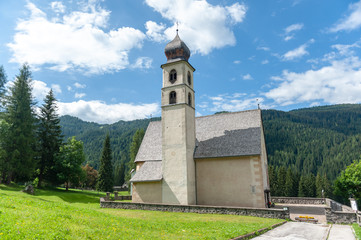 Fototapeta na wymiar The Church of the village of Santa Fosca in the Italian Dolomites