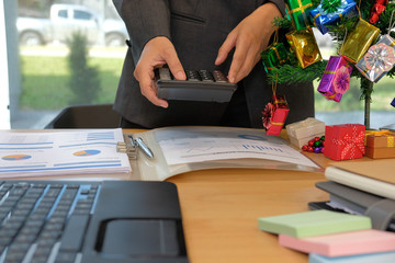 financial adviser use calculator to calculate revenue & budget. accountant doing accounting during...