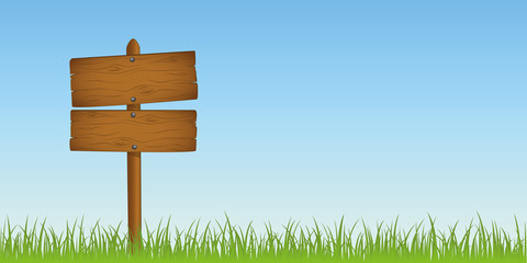 wooden sign in grass with copy space for your message
