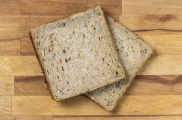 Two pieces of toast on wooden table