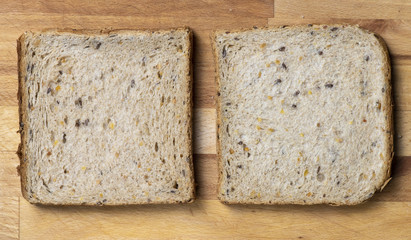 Two pieces of toast on wooden table