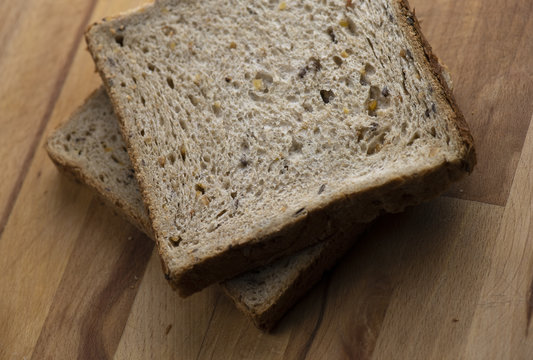 Two Pieces Of Toast On Wooden Table