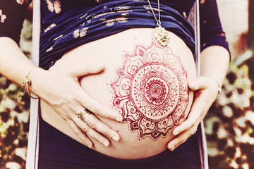 Pregnant belly with henna drawing decoration