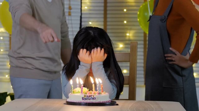 Little girl with stress situation about father and mother arguing in her birthday.