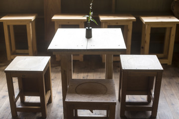 Interiors of a cafe. wood tables and chairs. Vintage classroom effect.