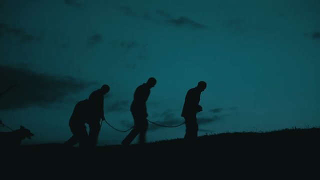 Prisoners and communist militia at midnight. The clip can illustrate Persecution of Christians in the Eastern Bloc.