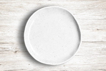 Fototapeta na wymiar Top view of empty white food dish on a wooden background.