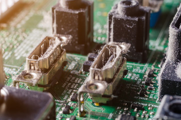 A thick layer of dust covers the internal electronic components of the computer