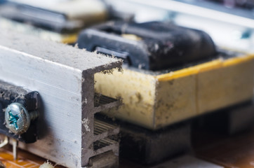 A thick layer of dust covers the internal electronic components of the computer