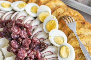 Traditional cutted south tyrolean Kaminwurz with cooked egg and fried vegetables
