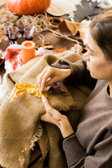 Busy woman sewing burlap in workshop