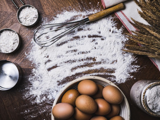Pastry Baking Accessories Bakery Background with flour and whisk. Ingredients for the preparation of bakery products.