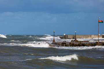 Electric Lamps in the Boardwalk near the Coastline hit by Sea Waves during Storm