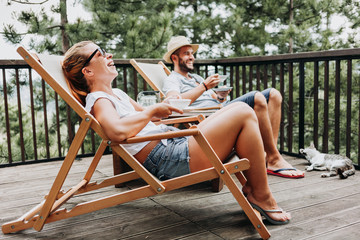 Couple enjoying coffee on a balcony in the mountains