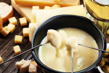Gourmet Swiss fondue dinner on a winter evening with assorted cheese